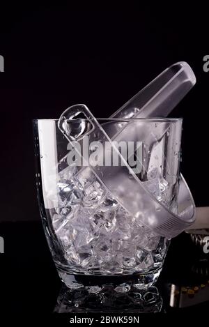 Glass ice bucket isolated on black with copy space Stock Photo