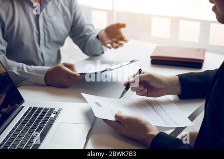 Asian young adult sitting at desk across from manager being interviewed job interview in business room. Stock Photo