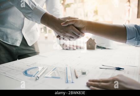 Two engineering man with construction worker greeting a foreman at renovating apartment. Stock Photo