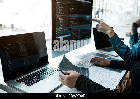 Two asian team working development of programming and encryption technology website design programmers on desk in office. Stock Photo