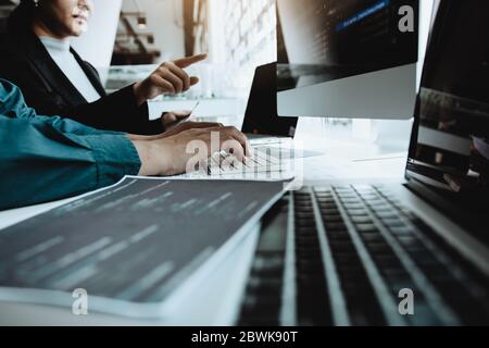 Developing programming and coding technologies working in a software engineers developing applications together in office. Stock Photo