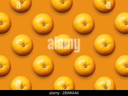 Whole fresh oranges on orange background. Set of colorful citrus fruit pattern. Stock Photo