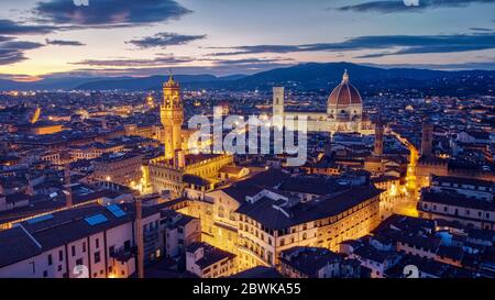 Florence landscape view at dusk with Palazzo Vecchio and Duomo di Santa Maria del Fiore with city lights Stock Photo