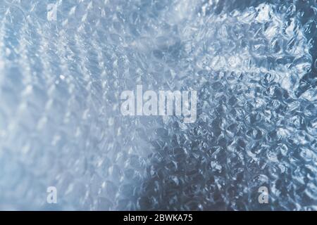 Plastic bubble wrap texture. Backdrop of blue bubble package, shot in low key Stock Photo