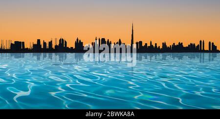 Dubai skyline. Panoramic view with infinity pool and silhouette of the city at sunset. Stock Photo