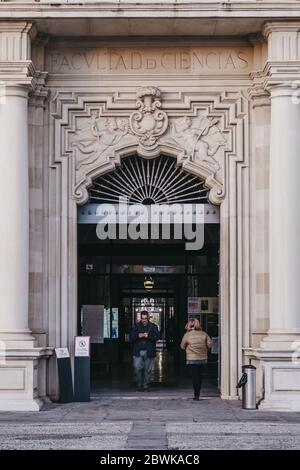 Seville, Spain - January 17, 2020: Entrance of Seville University, one of the top-ranked universities in the Spain, people walking through, motion blu Stock Photo