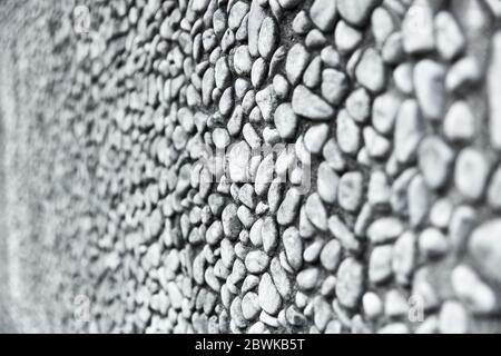 Wall or wall with lots of gray pebble stones as a background Stock Photo