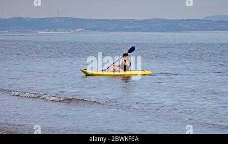 Portobello, Edinburgh, Scotland, UK.  2nd June 2020,15 degrees early morning with hazy sunshine encourages leisurely activity at the seashore on the Firth of Forth, people making the best of it before below average temperatures return for the next few days. Stock Photo