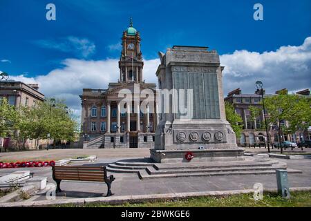 The Cenotaph and Town Hall in Hamilton Square in Birkenhead, Wirral Merseyside, taken on a sunny day with white clouds. Stock Photo