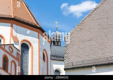 Close up of a small church tower with golden colored cross on top. At Andechs Abbey. Stock Photo