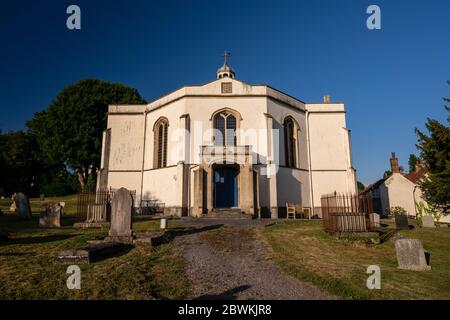 Wedmore, England, UK - May 31, 2020: Sun shines on Holy Trinity Church in the village of Blackford in Wedmore, Somerset. Wedmore, England, UK - May 31, 2020: Sun shines on Holy Trinity Church in the village of Blackford in Wedmore, Somerset.
