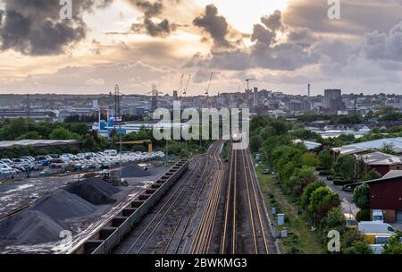 Bristol, England, UK - April 30, 2020: A local passenger train approaches Bristol Temple Meads station on the Great Western railway, passing industria Stock Photo