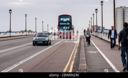 London, England, UK - June 18, 2013: Pedestrians, cyclists, motorists and a double-decker bus cross Wandsworth Bridge in West London. Stock Photo