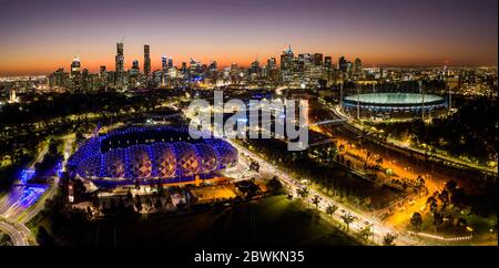 Melbourne Australia May 15th 2020 : Aerial panoramic night view of AAMI stadium aalongside the MCG and the city of Melbourne at sunset Stock Photo