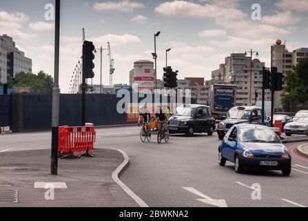 London, England, UK - July 30, 2011: Cyclists and motor traffic pass through the junction of Blackfriars Bridge and Queen Victoria Street during rebui