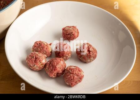 Raw meatballs on a white plate, cooking concept, food preparation, selected focus, narrow depth of field Stock Photo