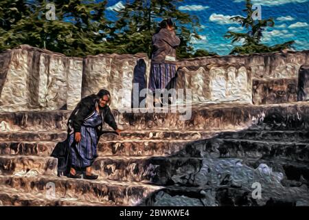 Women on a temple-pyramid with architecture in talud-tablero style at the Maya city of Zaculeu, in Guatemala. Stock Photo