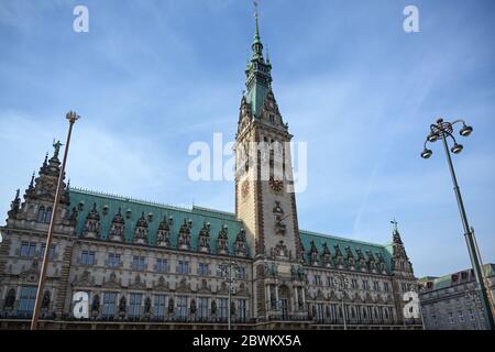 Historical town hall with clock tower in the city of Hamburg against a blue sky with clouds, copy space Stock Photo