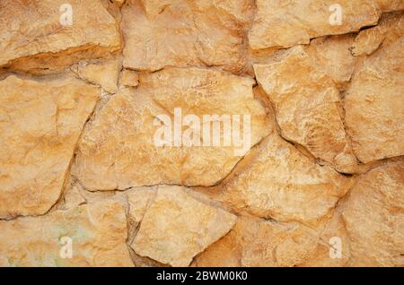 Old background orange stone wall close up, texture abstract Stock Photo