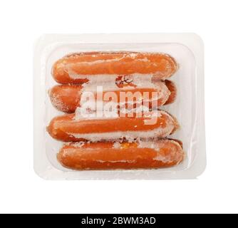 Sausages in vacuum packaging in ice isolated on a white background. A pack of sausages from a store isolated on a white background. Stock Photo