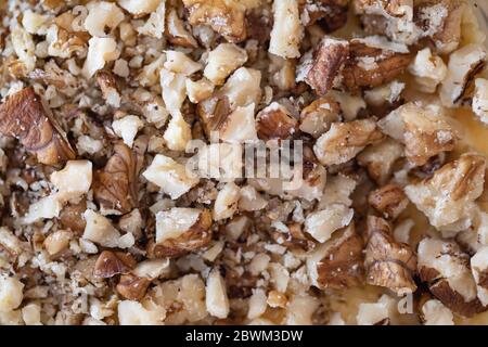 close up photo of crushed walnuts as food background or texture Stock Photo
