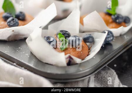 Blueberry homemade muffins with berries on a table Stock Photo