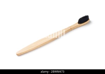Bamboo wood toothbrush with black brush bristles isolated on a white background Stock Photo