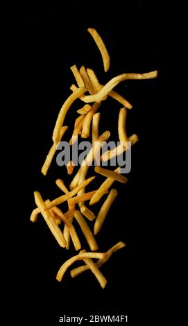 French fries flying in the air isolated on black background, Stop motion Stock Photo