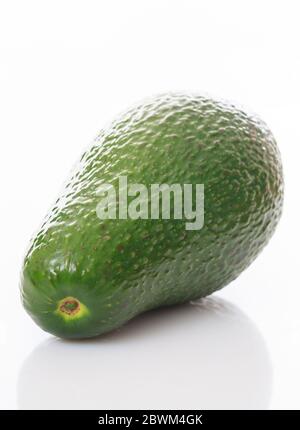 Healthy lifestyle concept. One avocado whole isolated on white background. Fresh, green fruit for slim size, dieting, vegan, vegetarian. Vertical phot Stock Photo