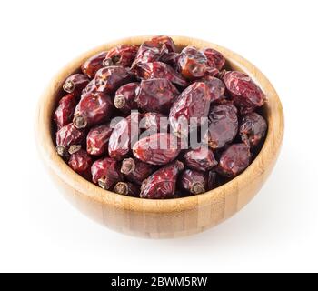 Dried wild rose berries in wooden bowl isolated on white background with clipping path Stock Photo