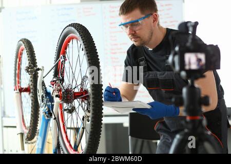 Handsome bearded male person making notes during work Stock Photo