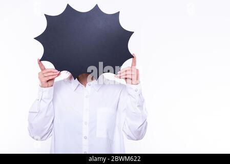 Woman holding black figured chalkboard infront of face. Photo on the white background. Stock Photo