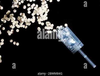 Silver glitter confetti paper cut on black background. Stock Photo