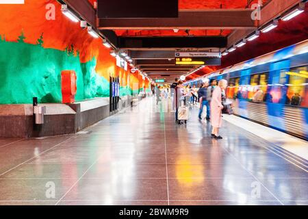 STOCKHOLM, SWEDEN - AUGUST 19, 2019: Interiors of Solna subway station in Stockholm, Sweden. Unidentified people and metro train at the station Stock Photo