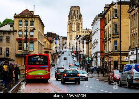 BRISTOL, UK - MAY 17, 2017: Famous street in the center of Bristol, UK during the rainy day. Bright cloudy sky. Various shops, cafes and restaurants. Stock Photo