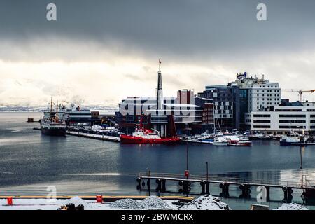 Tromso, Norway. Cloudy day in famous north town Tromso, Norway. View of the fjord with houses, mountain Stock Photo