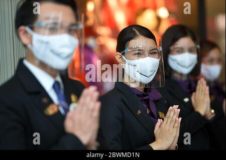 (200602) -- BEIJING, June 2, 2020 (Xinhua) -- Staff welcome customers at the entrance of a shopping mall in Bangkok, Thailand, May 17, 2020. (Xinhua/Rachen Sageamsak) Stock Photo