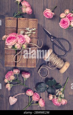 Pink flowers and the old books on a brown background Stock Photo