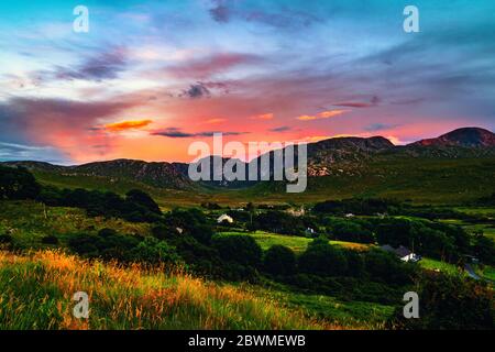 Donegal, Ireland. Landscape in Dunlewey with abandoned church in Donegal, Ireland. Colorful sunset sky. Green landscape in the evening Stock Photo