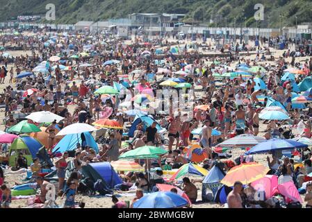 People on the beach in Bournemouth, Dorset, as the public are being reminded to practice social distancing following the relaxation of the coronavirus lockdown restrictions in England. Stock Photo