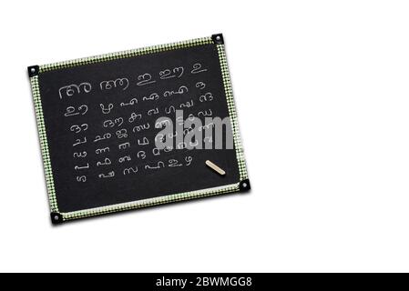 Incomplete Malayalam alphabets written on a kid's slate board isolated on white background. Stock Photo