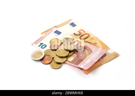 Money check in an economic and medical crisis, some dirty euro coins and banknotes with risk for infection by coronavirus, isolated on a white backgro Stock Photo