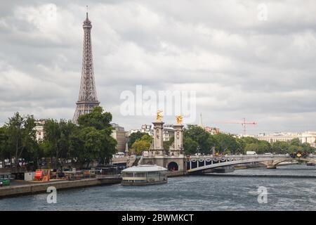 Paris, France - July 13 2019: Boat sailing the Seine river with the Eiffel tower in the background, Paris, France Stock Photo