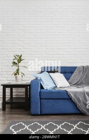 Grey sofa against blue curtains in the room Stock Photo Alamy