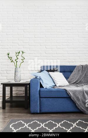 Grey sofa against blue curtains in the room Stock Photo Alamy