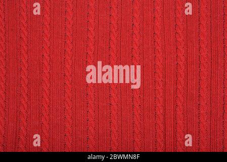 Knitted background. Knitted red texture. A knitting pattern of wool. Knitting. Background. Stock Photo