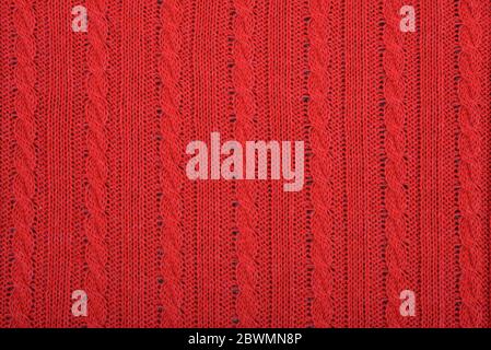 Knitted background. Knitted red texture. A knitting pattern of wool. Knitting. Background. Stock Photo
