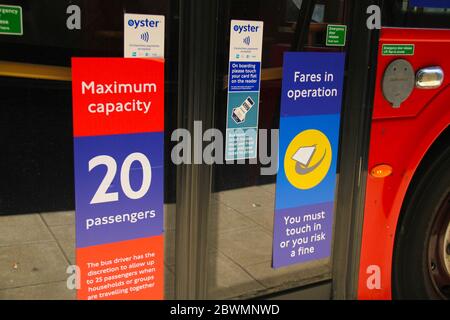 London, UK - 2  June 2020:  TFL buses with new signs restricting the number of passangers on to  the buses to maintain social distancing. Only 10 on single deck buses and 20 for a double deck bus. Some non-essential stores, car dealerships and outdoor markets in Britain on June 1 were able to reopen from their COVID-19 shutdown in an easing of coronavirus lockdown measures. Photo: David Mbiyu/ Alamy News Live Stock Photo