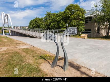 The Infinity Bridge in Stockton on Tees,England,UK with direction sign posts for Middlesbrough and Stockton Stock Photo
