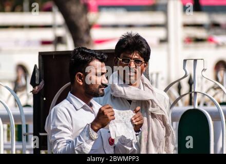Nagpur, Maharashtra, India - March 2019: A candid portrait of an Indian man wearing glasses and dressed in white on the streets of the city. Stock Photo